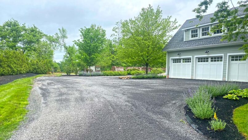 Gravel driveway around garage