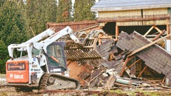 Demolition service with skid loader