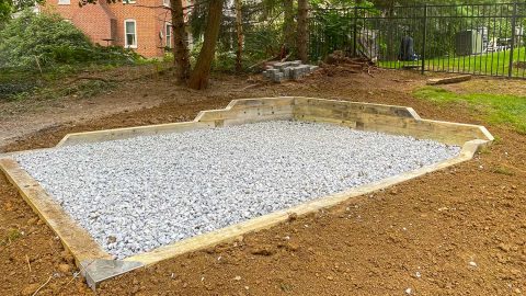 Signature stone base foundation with corner retaining wall