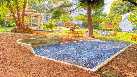 Stone base foundation with corner retaining wall