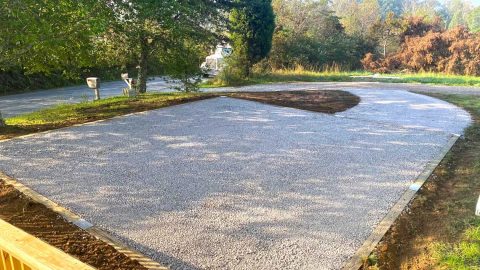 Signature stone base foundation integrated into driveway extension