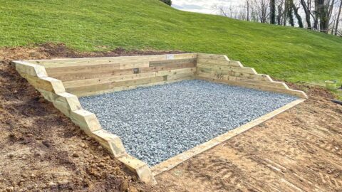 Shed pad with three side retaining wall
