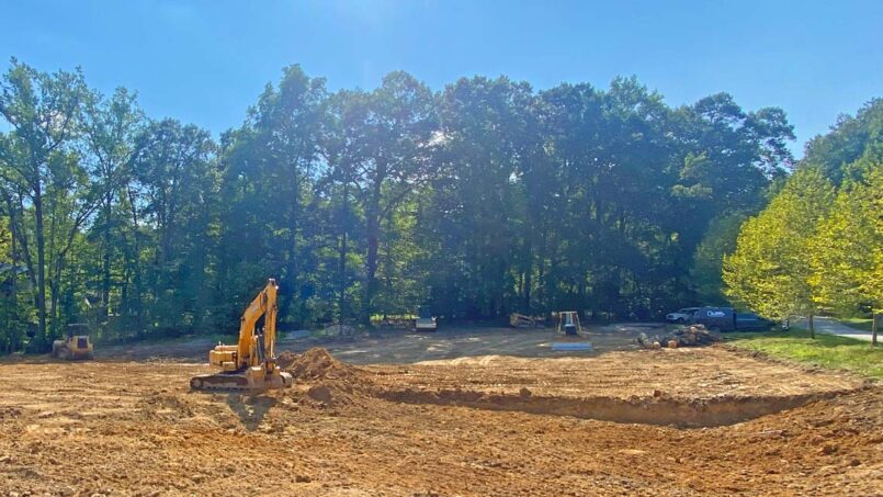 Excavating the athletic field to gain a level surface