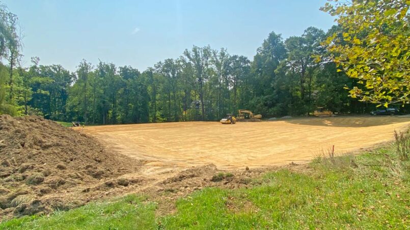 After excavation to level, adding and compacting topsoil