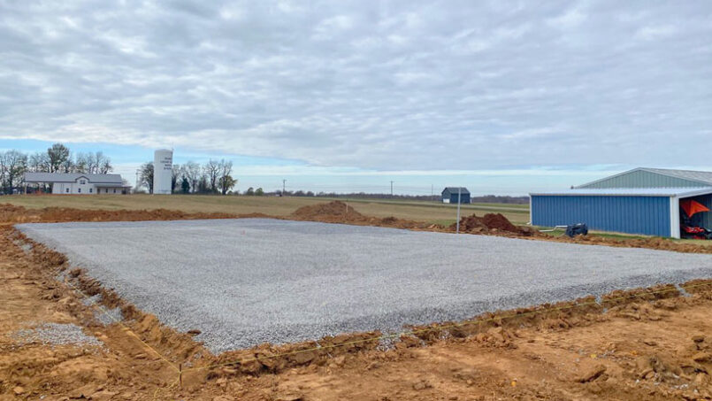 A stone base is applied and graded before the first concrete pour