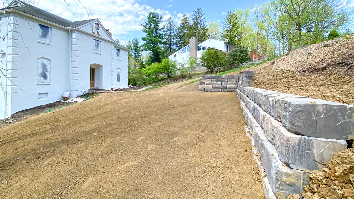 Boulder retaining wall finished grade