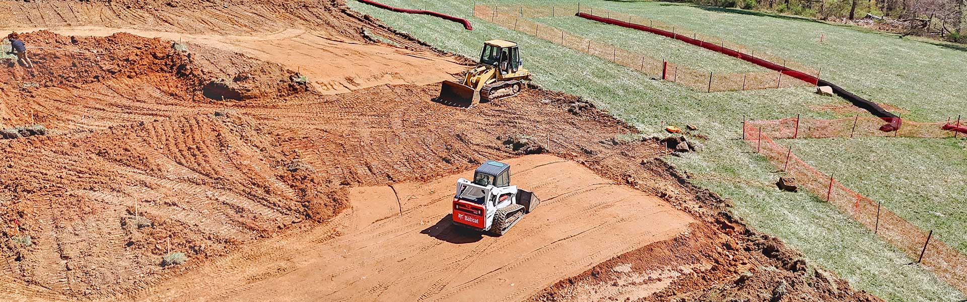 Excavation site with bulldozer and skid loader